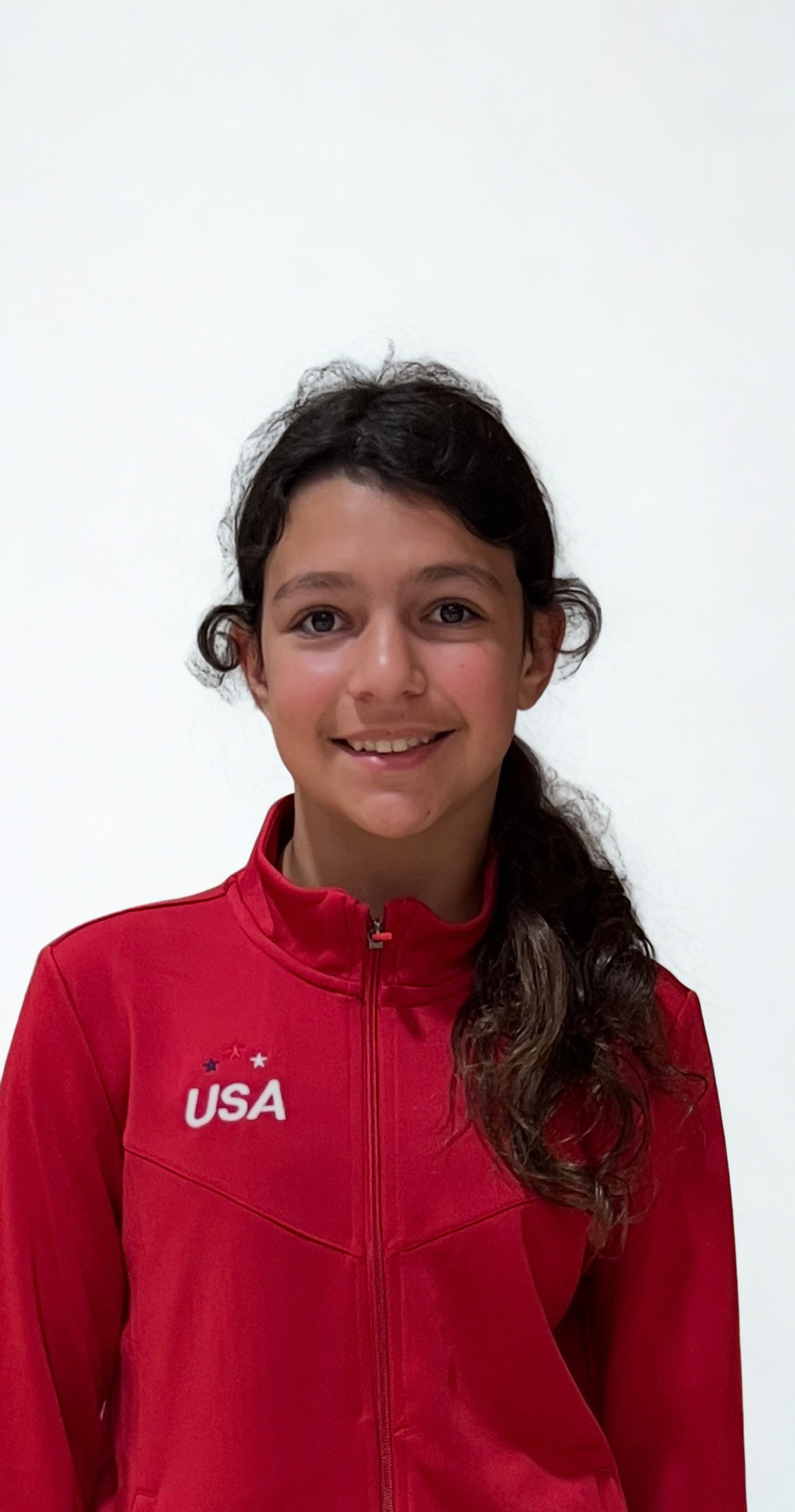 Skye Hudson smiling in her red USA warm-up jacket